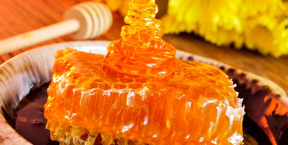 orange blossom honey drizzled onto honeycomb